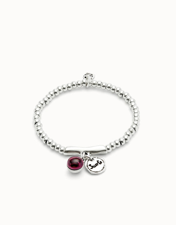 Beaded stretch bracelet with a murano glass and Suerte charm (silver)