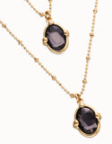 Multi strand necklace with two black oval faceted crystals, gold